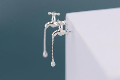 The Tab- Earrings — close-up of silver-tone tap-shaped earrings