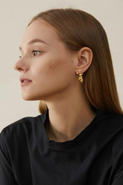 The Stars-Earrings — model wearing a gold-tone star earring