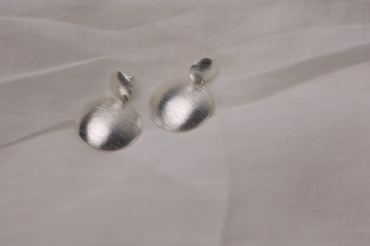 Handcrafted Frosted Minimalist Statement Earrings — round drop earrings on pale fabric