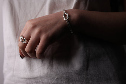 Model wearing knot ring with bangle