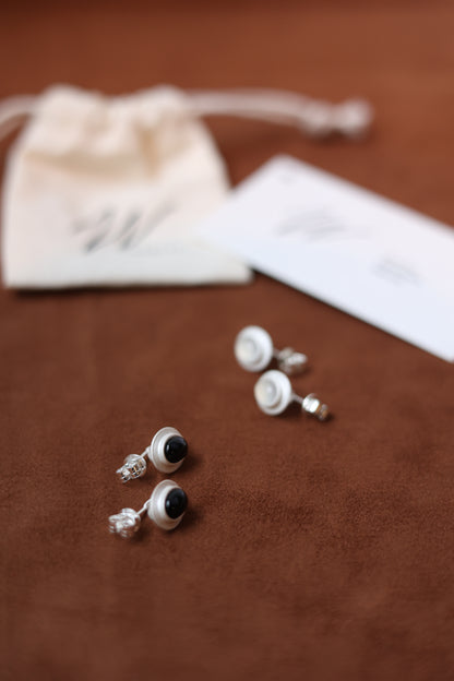 The Classic Agate-B & W — stone earrings displayed on a wooden surface