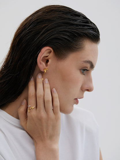 The Tab- Earrings — model wearing gold-tone tap-shaped earring