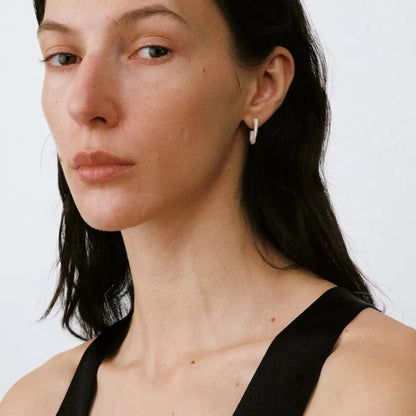 The Seashell-Ear Hoop — model wearing a textured hoop with a black top