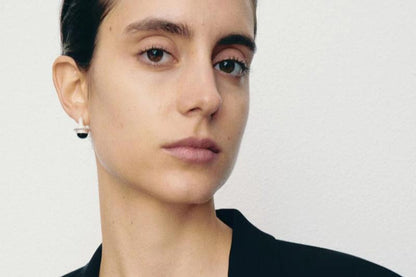 The Classic Agate-B & W — model wearing silver earrings with round stone details