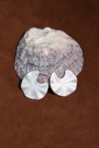 The Windmill-Earrings — windmill-shaped earrings beneath shell