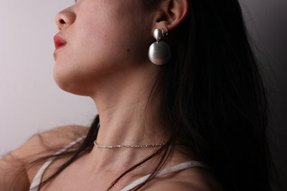 Handcrafted Frosted Minimalist Statement Earrings — side view of model wearing round drop earrings