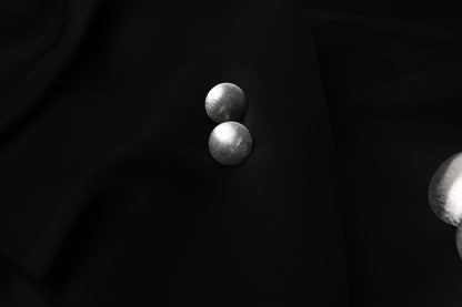 Minimalist Handcrafted Frosted Silver Ear Stud — round frosted studs on black fabric