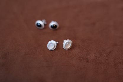 The Classic B & W Onyx Ear Stud — black and white studs on brown surface