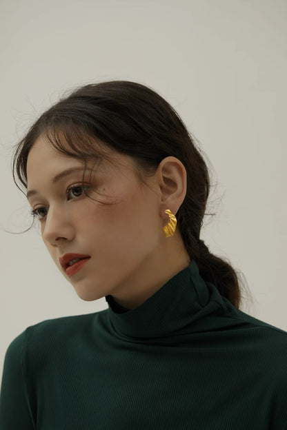The Origami-Earrings — model wearing gold-tone folded earring
