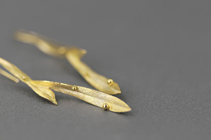 Wind Earrings — close-up of gold-tone elongated earrings