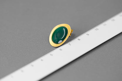 The Color Drop-Earrings — green oval earring photographed beside a ruler