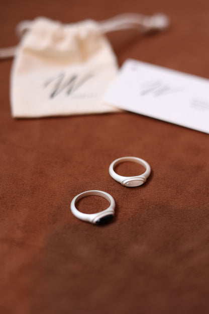 The B & W Onyx Ring — oval rings beside branded cards
