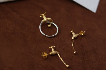 The Tab-Handcrafted Silver Set — tap-detail ring and earrings set on brown surface