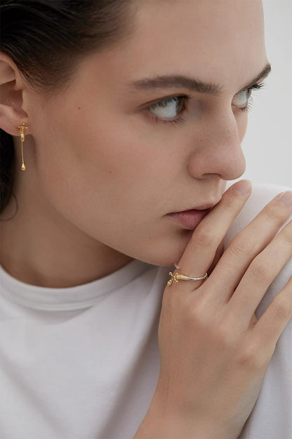 Model wearing a tap ring with coordinating earrings