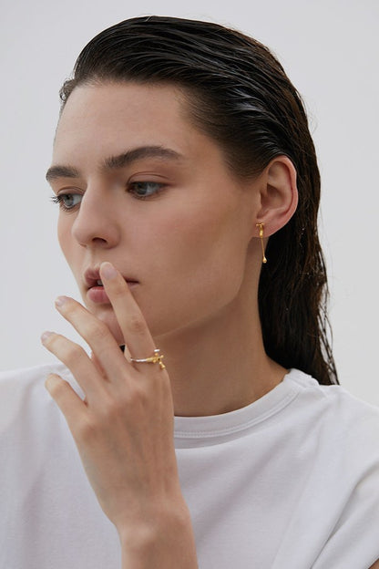 The Tab- Earrings — model wearing tap-shaped earrings with matching ring