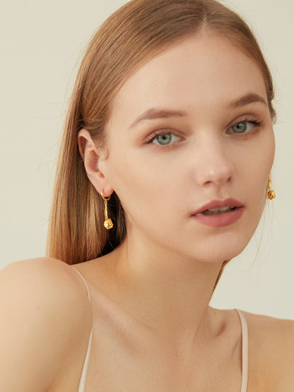 The Tulips-Earrings — front view of model wearing gold-tone tulip earrings