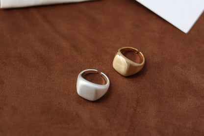 The Minimal Signet Ring — silver-tone and gold-tone signet rings side by side