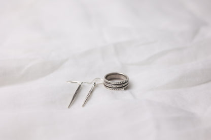 The Tribe Set — textured ring and drop earrings arranged on fabric