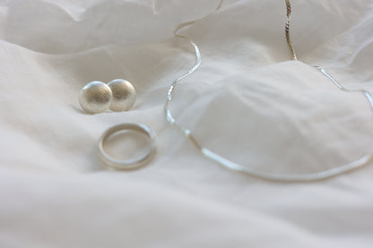 The Minimalist Set — close-up of smooth necklace, studs and ring