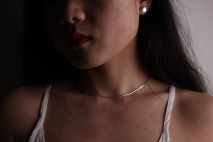 Minimalist Handcrafted Frosted Silver Ear Stud — round stud worn with smooth chain necklace