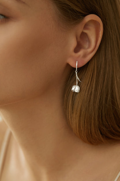 The Tulips-Earrings — silver-tone tulip earring worn on an ear