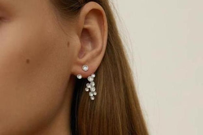 The Stars-Earrings — silver-tone star drop earring worn on an ear