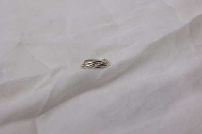 Handcrafted Interlocked Round Silver Ring — side view of interlocked bands on fabric