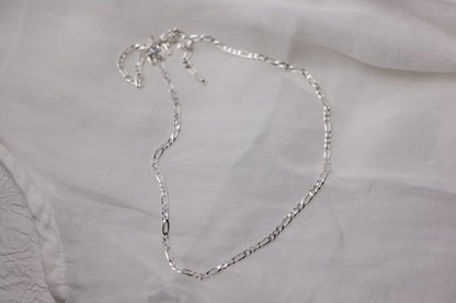 Handcrafted Minimalist Silver Chain Necklace — chain necklace arranged on pale fabric