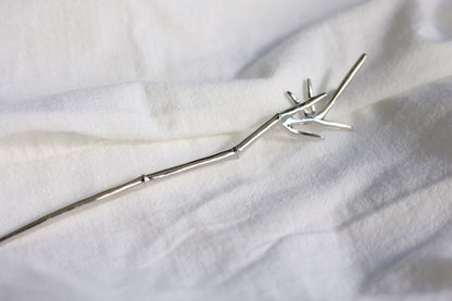 Bamboo Hair Pin — bamboo-leaf detail of hair pin on pale fabric