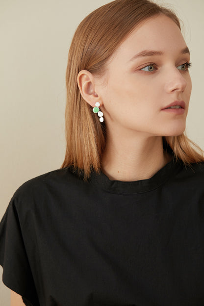The Stones-Earrings — model wearing silver-tone drop earrings with green accents