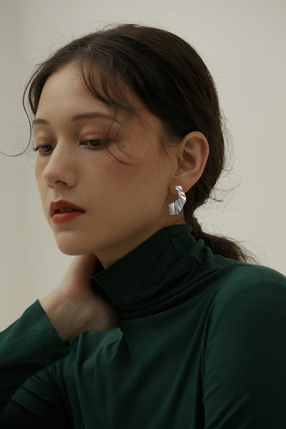 The Origami-Earrings — model wearing silver-tone folded earring