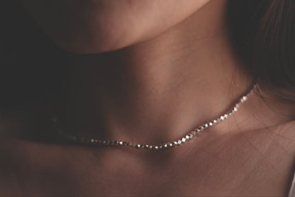 Minimalist Handcrafted Silver Beaded Necklace-Thick — close-up of beaded necklace worn around the neck