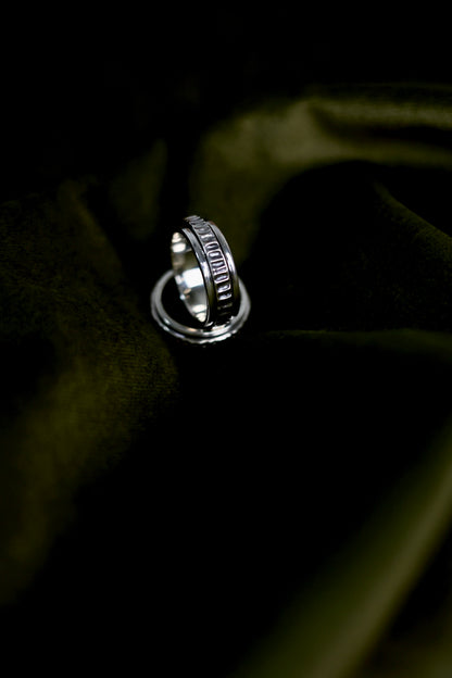 The Circles-Ring — spinning ring on dark green fabric