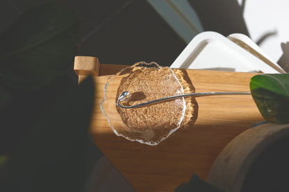 Magnolia Flower Hair Pin — magnolia-shaped hair pin resting on wood