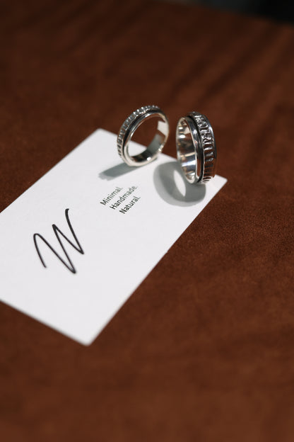 The Circles-Ring — two spinning rings beside branded card