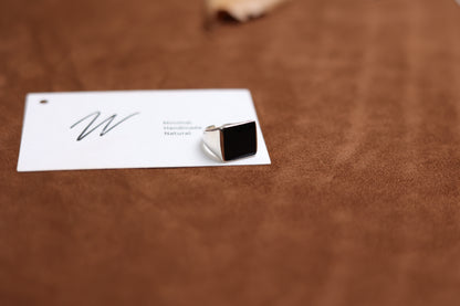 The Square Signet Ring with Black Onyx — square black-stone ring viewed from front
