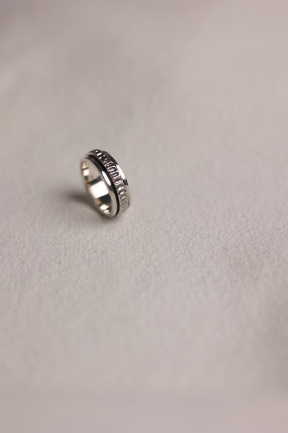 The Circles-Ring — spinning ring standing on pale fabric
