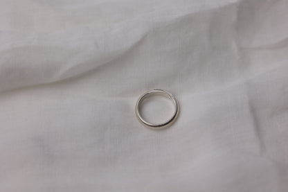 Handcrafted Minimalist Basic Silver Ring — top view of smooth band on fabric