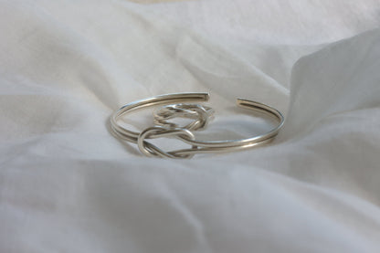 The Knot Set — close-up of knot ring and bangle on fabric