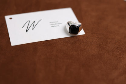 The Smoky Quartz Signet Ring — angled view of dark-stone signet ring