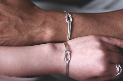 Handcrafted Minimal Style Silver Bangle-The Knot — close-up of knot bangles on two wrists