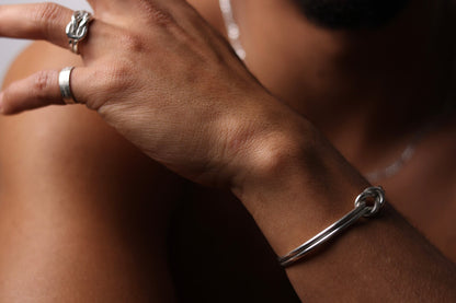 Handcrafted Minimal Style Silver Bangle-The Knot — knot bangle worn with silver rings