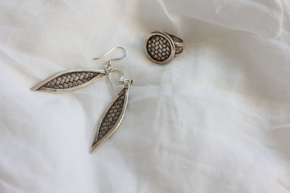 The Weaved Set — woven-pattern jewelry set on pale fabric