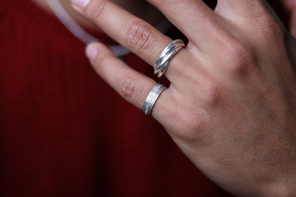 Handcrafted Interlocked Round Silver Ring — interlocked ring worn with other silver rings
