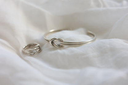 The Knot Set — knot ring and bangle arranged on fabric