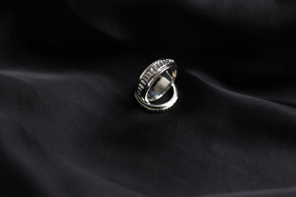 The Circles-Ring — textured spinning ring on black fabric