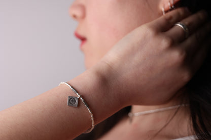The SUN Set — sun-pendant bracelet worn on a wrist
