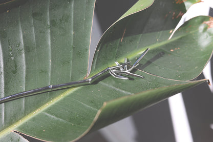 Bamboo Hair Pin — bamboo-shaped hair pin on a green leaf