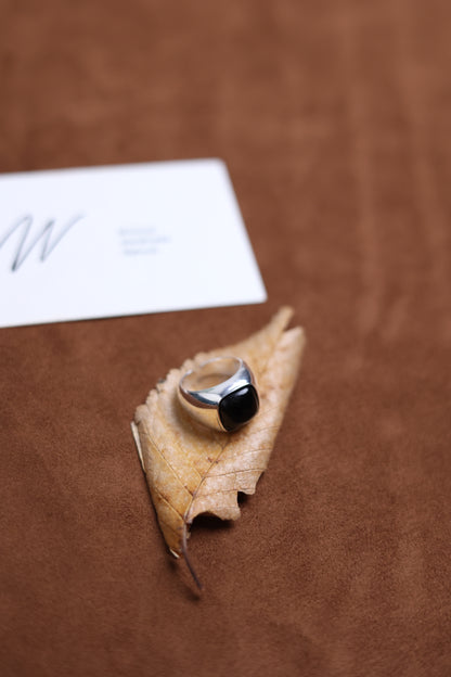 The Smoky Quartz Signet Ring — close-up of signet ring on dried leaf