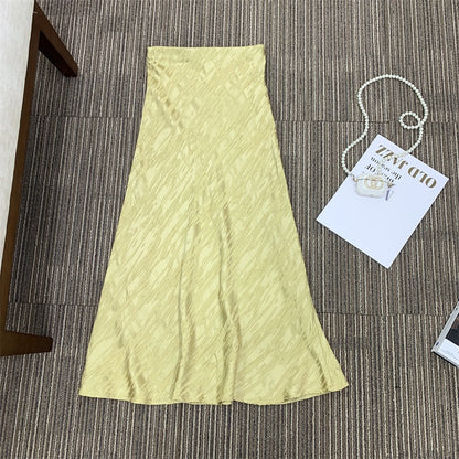 Gold Triacetate Skirt — gold-coloured skirt laid flat with tag